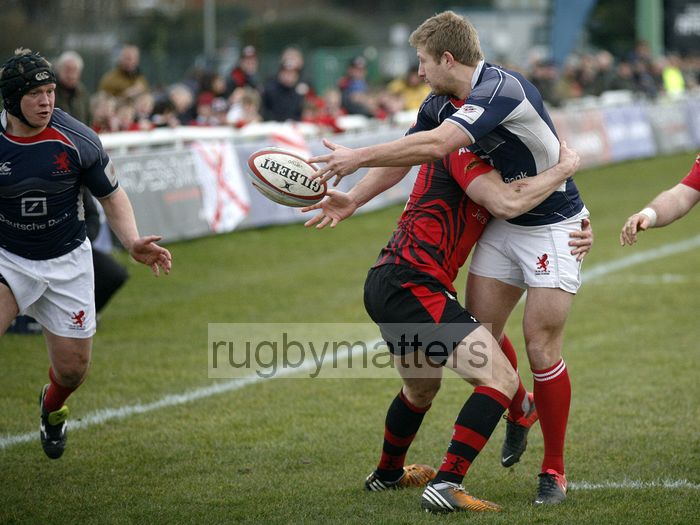 Richard Bolt offloads the ball while being tackled by his opposite number, Nicky Griffiths, to Adam Kwasnicki and he goes on to score a try. London Scottish v Jersey at Richmond Athletic Ground, Kew Foot Road, Richmond on 2nd March 2013 KO 1400.