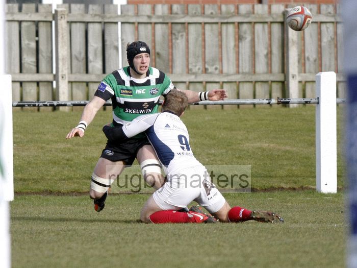 Jacob Rowan offloads the ball whilst being tackled by Richard Bolt. Leeds Carnegie v London Scottish at Brantingham Park, Brantingham Road, Brough, East Yorkshire on 10th March 2013 KO 1500.