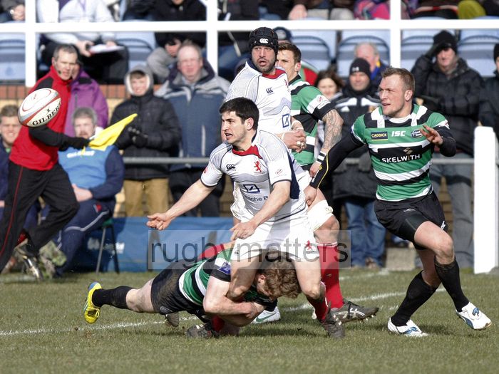 Andy Reay offloads the ball as Fred Burdon tackles him. Leeds Carnegie v London Scottish at Brantingham Park, Brantingham Road, Brough, East Yorkshire on 10th March 2013 KO 1500.