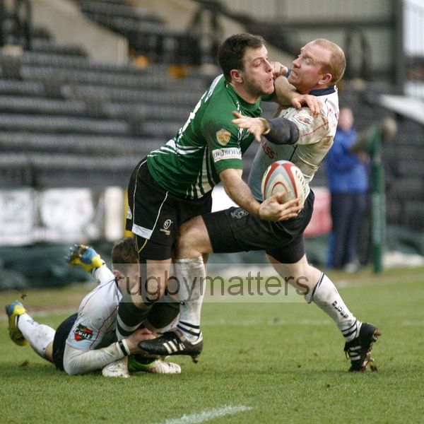 Rhys Crane off loads the ball in the tackle, tackled by Josh Bassett and Brendan Burke.  Nottingham v Bedford at The County Ground, Nottingham on the 27th January 2013. RFU Championship - Stage 1.