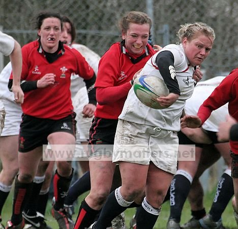 Amy Turner under pressure from Clare Flowers and Mel Berry of Wales.