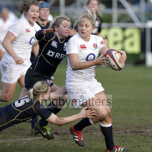 Ceri Large looks to offload the ball as Louise Dalgliesh and Stephanie Johnston make a tackle. England Women v Scotland Women at Esher RFC on 2nd February 2013.