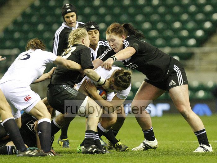 Marlie Packer tackled by Kendra Cocksedge, Justine Lavea and Casey Robertson.  England v New Zealand in Autumn International Series at Twickenham, England on 1st December 2012.
